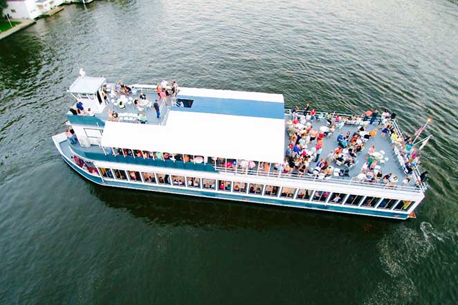 Aerial view of The Madam Carroll cruising Lake Freeman with a full deck of guests